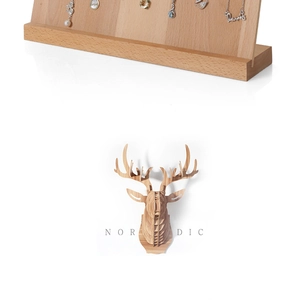Close-up of a solid wood necklace display stand and 3D wooden deer head wall mount