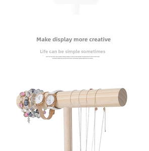 Detail of wooden T-bar display stand holding jewelry watches and bracelets in macro
