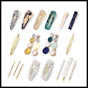 Flat lay of pearl and acetate hair clips set with gold metal finish on white background