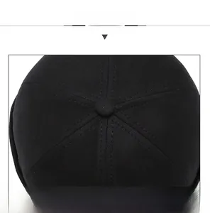 Detail of black cotton docker cap top with reinforced stitching and button
