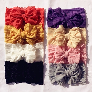 Set of 8 colorful baby headbands with large bows and textured elastic fabric