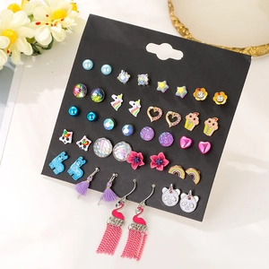 Detailed view of colorful children's earrings with unicorn, rainbow, and heart designs