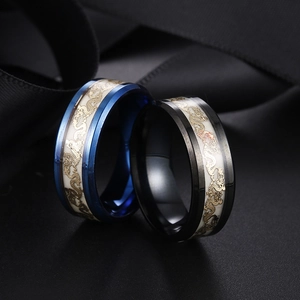 Macro shot of stainless steel dragon rings in blue and black with luminous finish