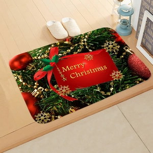 Close-up of Merry Christmas festive mat on wooden floor with seasonal decorations