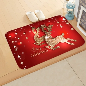 Detailed view of red Christmas floor mat with golden reindeer and stars on wooden floor