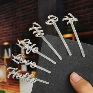 Close-up of six silver rhinestone hair pins with words Hella Love Life Kiss on black card
