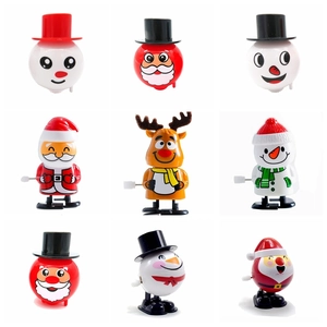 Nine diverse wind-up Christmas toys including Santa Claus, snowman, and reindeer figures