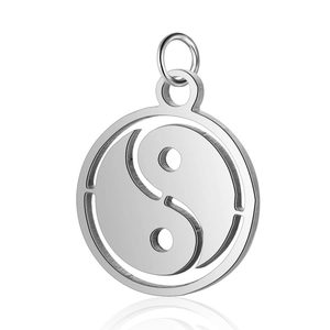 Macro detail of a silver stainless steel Tai Chi Yin Yang pendant with polished finish