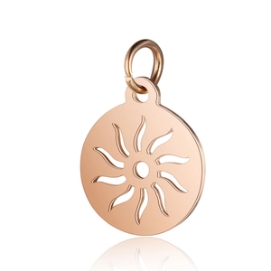 Detail of rose gold stainless steel round hollow pendant with sunburst flame pattern