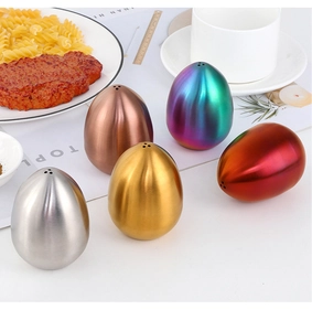 Macro shot of brushed stainless steel egg-shaped seasoning shakers in five metallic colors