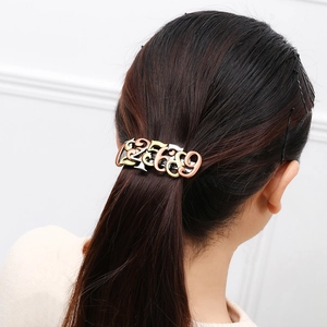 Steampunk bronze hair clip with numbers 25689 worn on a ponytail hair accessory