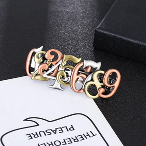 Detailed view of steampunk hair clips with brushed metal numbers on a black jewelry case