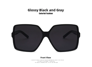 Front view of stylish oversized square sunglasses with glossy black frames and gray lenses