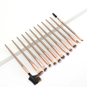 Detailed arrangement of 13 professional makeup brushes with rose gold ferrules