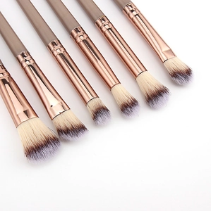 Close-up of 6 champagne gold makeup brushes with professional gradient soft bristles