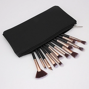 Detailed view of 12 professional makeup brushes with black PU leather storage case