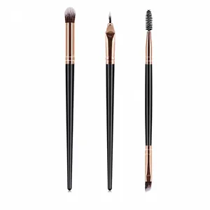 Detail of 3 professional makeup brushes with black handles and rose gold ferrules