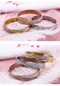 Close-up of cable style bracelets in gold, silver, and rose gold with pavé crystals