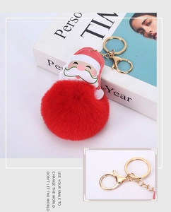 Detail of Santa Claus plush pompom keychain with golden metal lobster clasp and ring