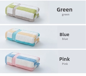 Close-up of three striped cotton towels in green, blue, and pink showing soft texture