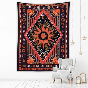 Detail of bohemian tapestry featuring a sun and moon totem in a cozy room setting