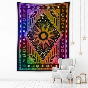 Detail of bohemian tapestry featuring celestial sun and moon in vibrant rainbow colors
