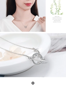 Detail of silver planet pendant necklace featuring white zircons and a model worn view