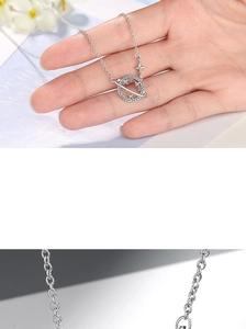 Macro shot of S925 silver Saturn pendant necklace with sparkling cubic zirconia stars