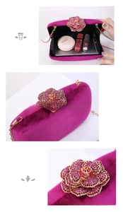 Detail of fuchsia velvet evening clutch with rhinestone flower buckle and gold chain