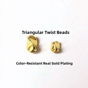 Close-up of 14K gold plated triangular twisted beads for DIY jewelry making accessories