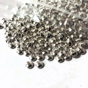 Close-up of bulk silver metal round spacer beads for DIY jewelry making and crafting