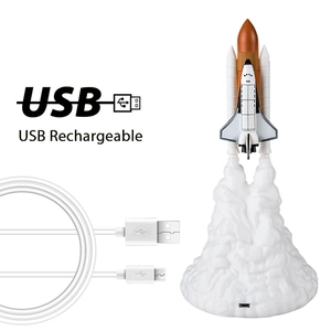 3D printed space shuttle rocket lamp with USB charging cable on white background