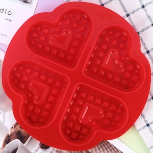Red 4-cavity heart shaped silicone waffle mold with grid pattern for baking