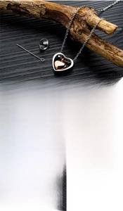 Three variants of stainless steel heart urn necklaces in rose gold, gold, and black finish