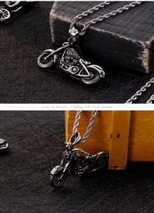 Detail of vintage punk motorcycle pendant with skull and engine textures on rope chain
