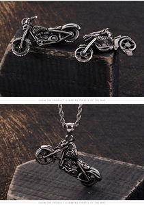 Macro detail of retro punk motorcycle pendant in oxidized silver stainless steel