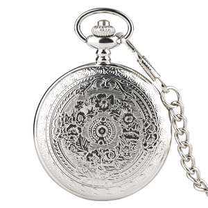 Detail of vintage silver pocket watch with intricate floral and geometric metal engravings