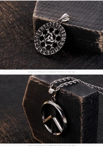 Macro detail of vintage Viking necklace showing Valknut runes and peace sign engraving
