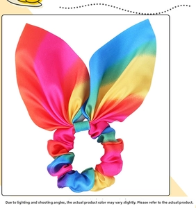 Detail of rainbow gradient satin scrunchie with rabbit ear ties and smooth texture