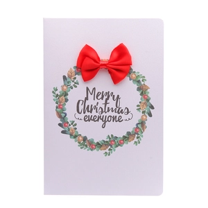 Christmas greeting card featuring a green leaf wreath with a 3D red ribbon bow