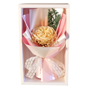 Close-up of beige gold foil rose with baby's breath in a white windowed gift box