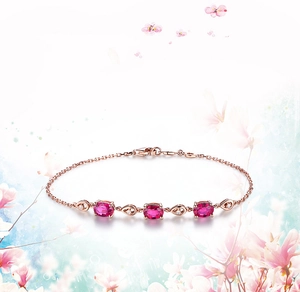 Detail of rose gold bracelet with pink oval gemstones and clear sparkling accents