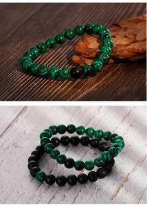 Detail of beaded bracelet with matte black onyx and green malachite natural stone textures
