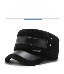 Detail of black winter flat cap featuring faux fur texture and metal brand tag