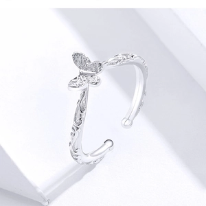 Detail shot of a s925 silver bow butterfly ring with intricate vine pattern engraving