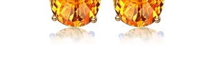 Detailed macro view of orange gemstone stud earrings with rose gold four-prong setting