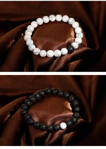 Detail of minimalist black lava and white turquoise beaded bracelets for couples