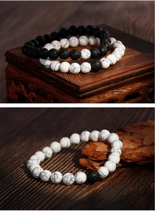 Close-up of black lava stone and white marble turquoise beaded bracelets for couples