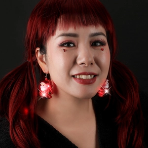 Glowing Santa Claus LED earrings for Christmas party wear shown on a model
