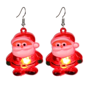 Detail of glowing Santa Claus earrings with red LED lights and festive holiday design